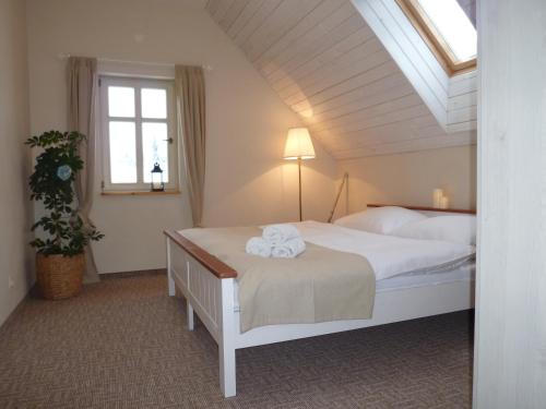 a bedroom with a bed with towels on it at Olivia House in Abertamy