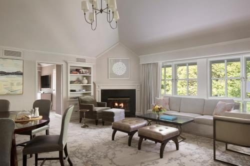 a living room with a couch and a fireplace at Lafayette Park Hotel & Spa in Lafayette