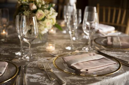 a table with plates and wine glasses on it at Lafayette Park Hotel & Spa in Lafayette