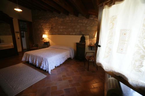 a bedroom with a white bed in a room at B&B Sciabakè in Polizzi Generosa