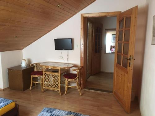 a room with a table and chairs and a door at Penzion Krásný Dvůr in Krásný Dvŭr