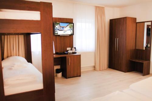 a bedroom with a bunk bed and a tv at Anor Hotel & Conference Center Frankfurt Airport in Mörfelden-Walldorf