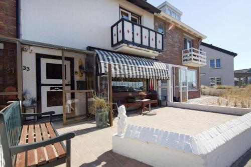 a dog sitting on a patio in front of a building at By Simonis in Zandvoort