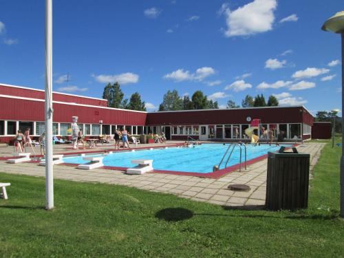 a large swimming pool with people playing in it at Stöde Camping in Edsta