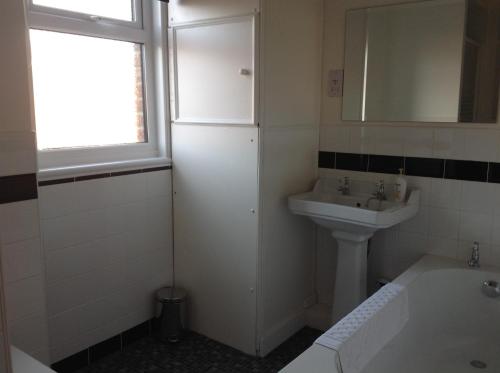 a bathroom with a sink and a bath tub at Cricket View cottage in Redcar