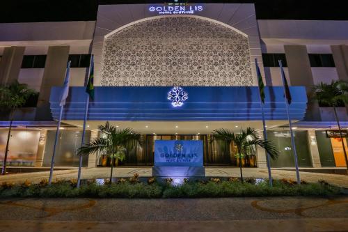 a building with a sign in front of it at Golden Lis Hotel Boutique in Goiânia