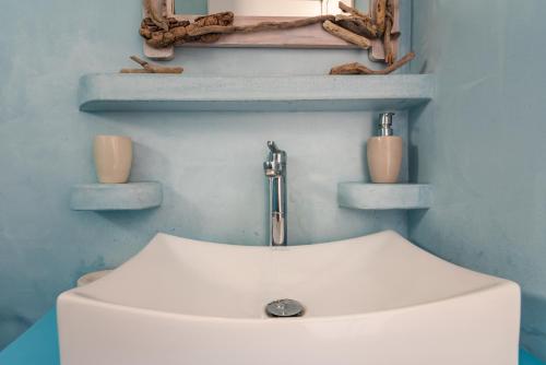a bathroom with a white sink and a mirror at Polyegos View in Pollonia