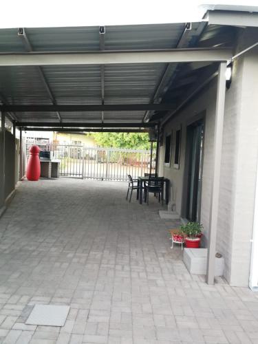 a patio with tables and chairs in a building at Kalahari Rus in Upington