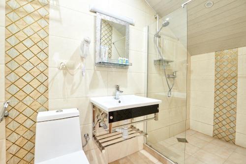 a bathroom with a sink and a shower at Hotel Diadema in Tbilisi City