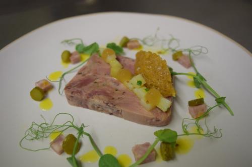 a plate of food with a piece of meat on it at The Plough Inn in Stalisfield