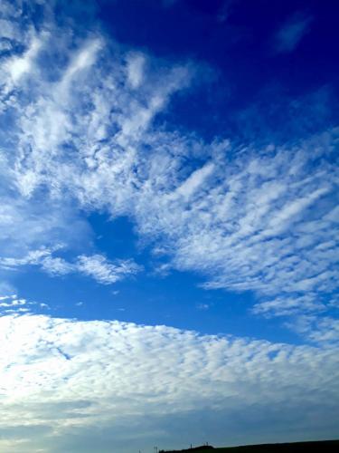 a blue sky with some clouds in the sky at Ferienhotel Alter Bahnhof garni in Prerow