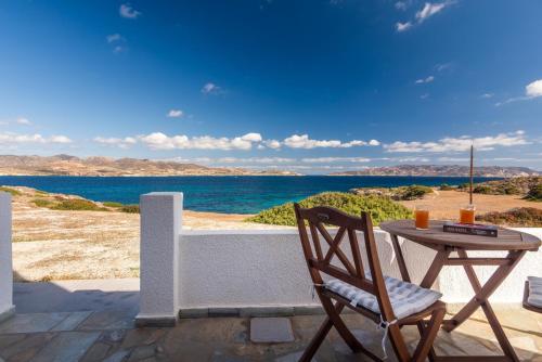 a table and chair on a patio with a view of the ocean at Polyegos View in Pollonia