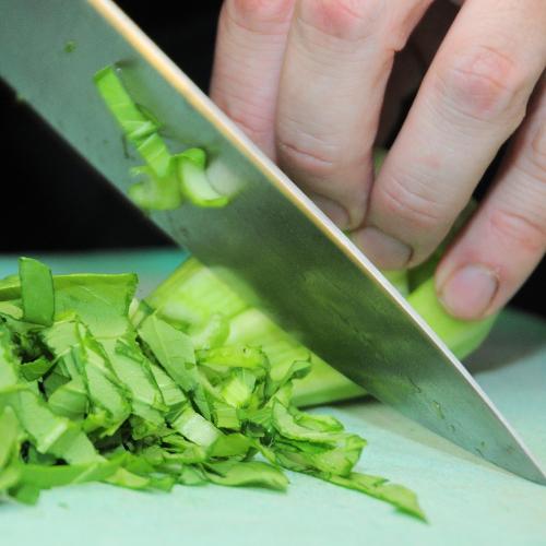 a person cutting up celery with a knife at ´t Wapen van Marion in Oostvoorne