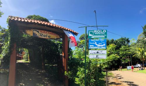 a sign for a hotel next to a street at Hostal Familiar Rolo in Santa Catalina
