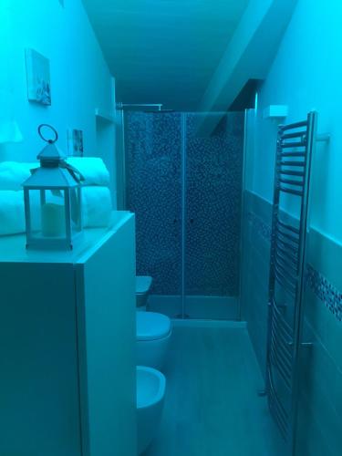 a blue bathroom with two toilets and a shower at PEPPE'S HOME Luxury and relax apartament in Gragnano