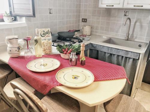 a kitchen with a table with two plates on it at Trulli Caroli in Locorotondo