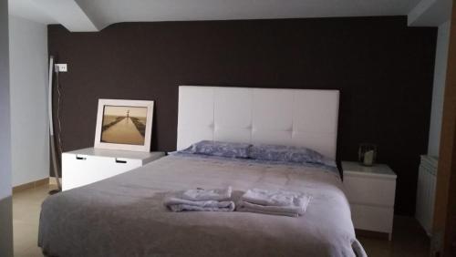 a bedroom with a large bed with two towels on it at Apartamento Laura in Gandara