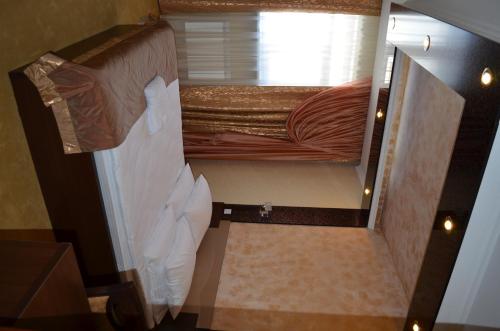 a small bedroom with a bunk bed in a room at Mereke Hotel in Ustʼ-Kamenogorsk