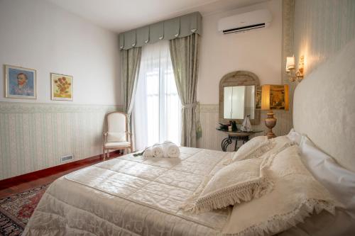a bedroom with a large bed and a window at A due passi olbia in Olbia
