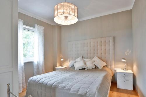 a bedroom with a large bed with a white headboard at Landvilla Pia in Attendorf