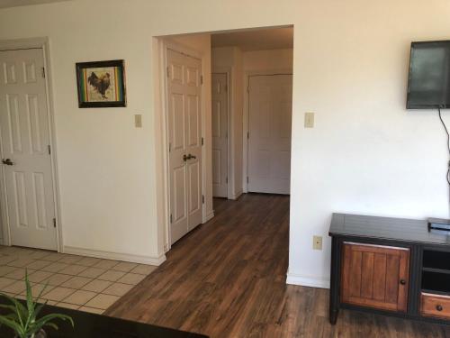 a living room with white walls and wooden floors at Perfect Country-Side Get-Away in Boerne