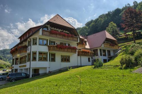 a large white house with balconies on a hill at Gasthaus Sonne in Münstertal