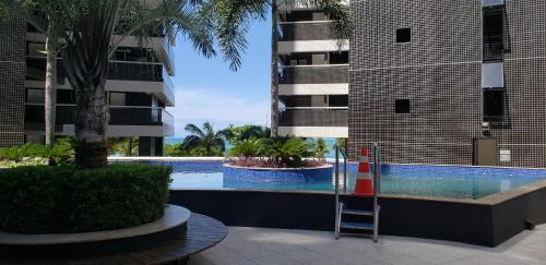 a swimming pool in the middle of a building at Landscape Diamond 1409 in Fortaleza