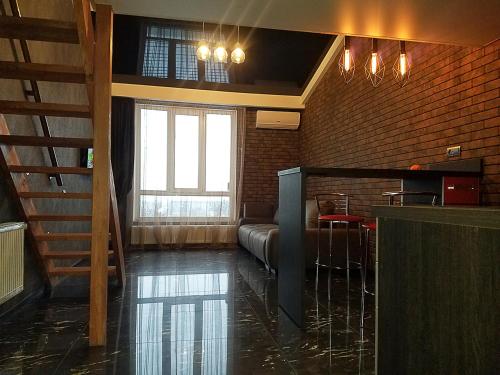 a lobby with a couch and a table in a room at В стиле LOFT 2ухэтажная квартира. in Kharkiv
