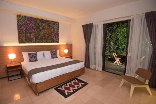 a bedroom with a bed and a large window at Nardazul "Casa de Sueños" in Oaxaca City