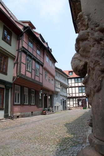 a cobblestone street in a town with buildings at Hotel am Hoken in Quedlinburg