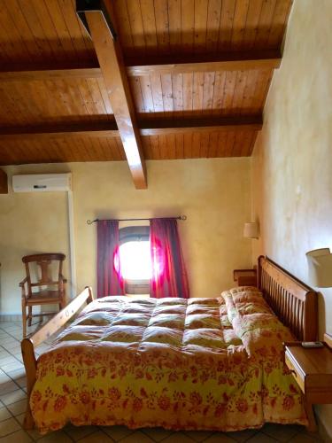 a bedroom with a large bed with a window at Agriturismo Il Pozzo in Polla