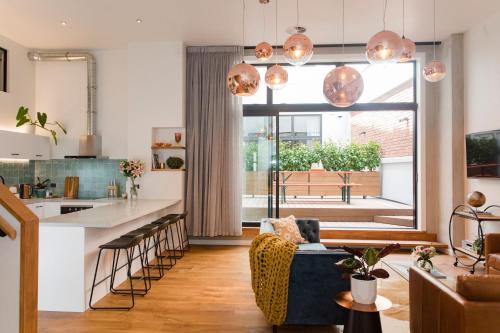 a kitchen and living room with a large window at Anzac North Loft - 4 Bedrooms & 2 Free Car Parks in Auckland