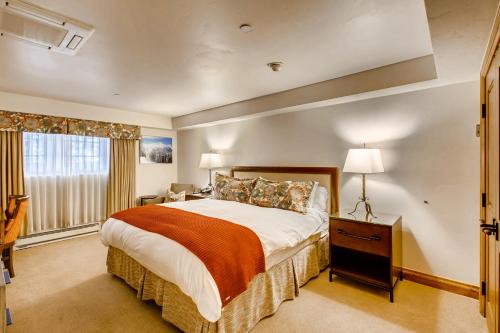 a bedroom with a large bed and a window at Gravity Haus Vail in Vail