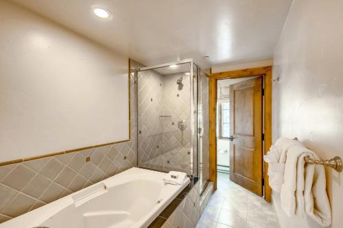 a bathroom with a bath tub and a shower at Gravity Haus Vail in Vail