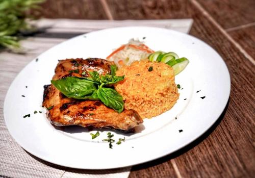 a white plate with food on a wooden table at Nacpan Beach Glamping Managed by H Hospitality Group in El Nido