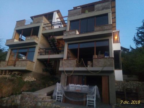 a building with two white chairs in front of it at APTO 102 EN "ABADIA de TOMINE" in Guatavita