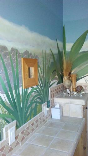 a bathroom with a mural of plants on the wall at Kokopelli's Hideaway in Julian