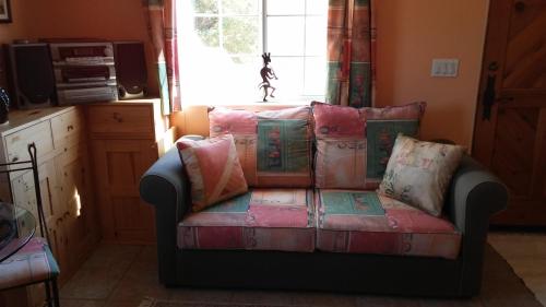 a couch sitting in a room with a window at Kokopelli's Hideaway in Julian