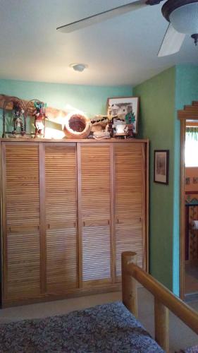 a room with a large wooden cabinet in a room at Kokopelli's Hideaway in Julian