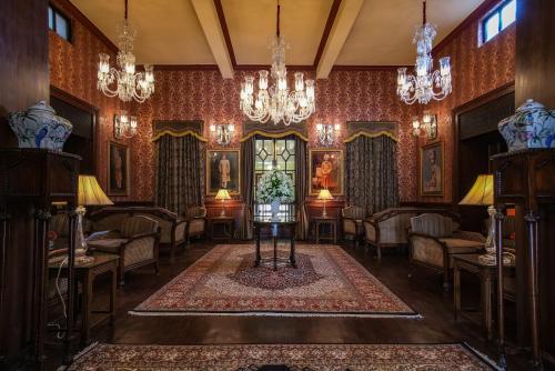 a living room with chairs and a chandelier at Ajit Bhawan - A Palace Resort in Jodhpur