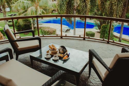 a tray of food on a table on a balcony at Vida Homes Condo Resort in Dauin