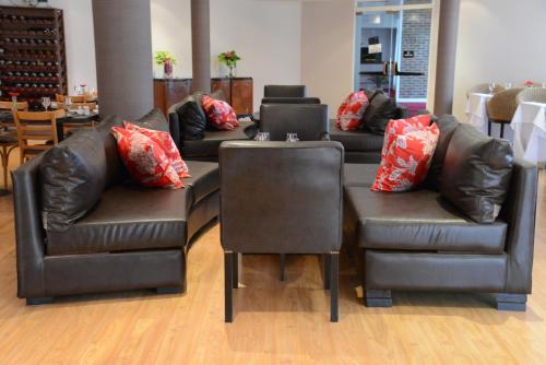a room with leather couches and a table and chairs at CATANGE HOTEL in Charata