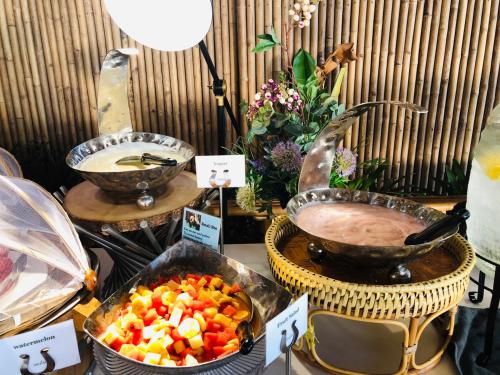 a buffet with two baskets of food and a bowl of fruit at Phi Phi CoCo Beach Resort in Phi Phi Don