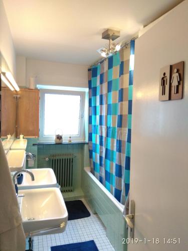 a bathroom with two sinks and a shower at The Old Doctors Office in Hamburg