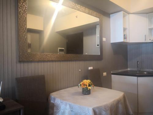 a table with a vase of flowers on it in a kitchen at Centrio Tower Beside Ayala Studio Unit with Balcony 23 in Cagayan de Oro