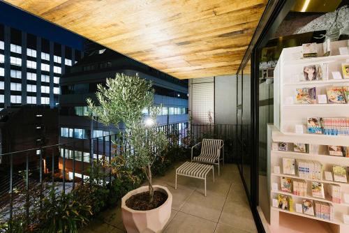 ein kleiner Baum in einem Topf auf einem Balkon in der Unterkunft MANGA ART HOTEL, TOKYO in Tokio