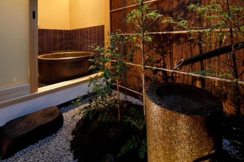 a bathroom with a toilet and a bath tub at Kyonoyado Gekkoan in Kyoto