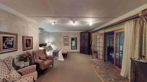 a living room with a couch and a bed at Ancient Emperor Guest Estate in Potchefstroom