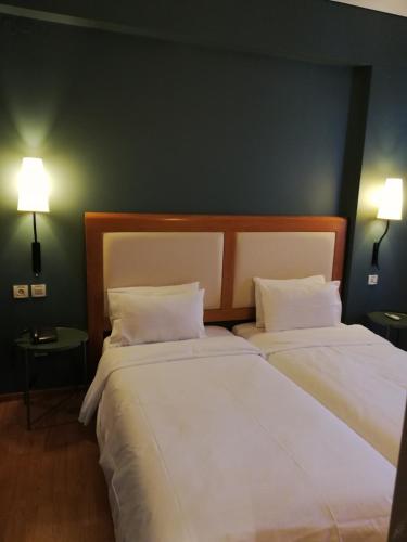 two beds sitting next to each other in a room at Olympic Hotel in Heraklio Town