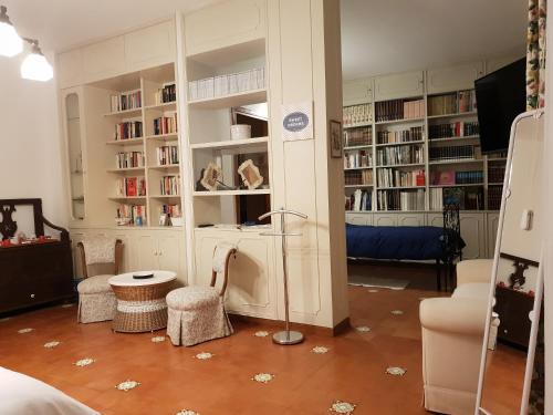 a living room with bookshelves and a lamp in it at La terrazza di Anna in Sassari